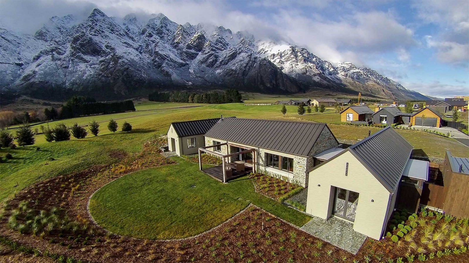 Jacks Point completed home — snow-capped Remarkables behind
