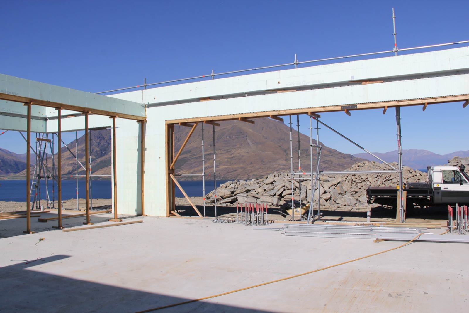 Te Toka during construction — ICF shell with Lake Wakatipu framed through the opening